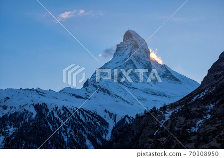 Beautiful view of village in sunrise time with Matterhorn peak background in Zermatt, Switzerland. Beautiful view of village in sunrise time with Matterhorn peak background in Zermatt, Switzerland. 70108950