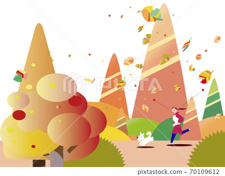 A woman and a dog running through a colored autumn forest 70109612