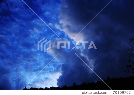 Northern Yatsugatake in early autumn, a magnificent sky at twilight looking up from a mysterious twin pond, monster clouds 70109762