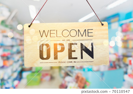 A business sign that says open on cafe or restaurant hang on door at entrance. 70110547