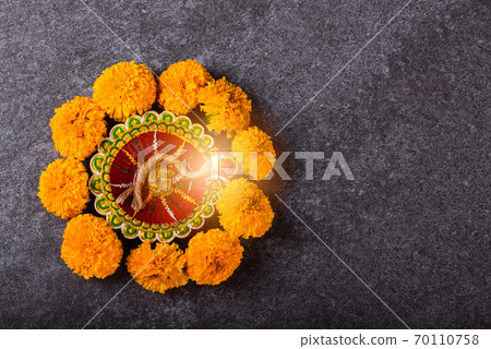 clay lit Diya or oil lamp and yellow flower clay lit Diya or oil lamp and yellow flower 70110758