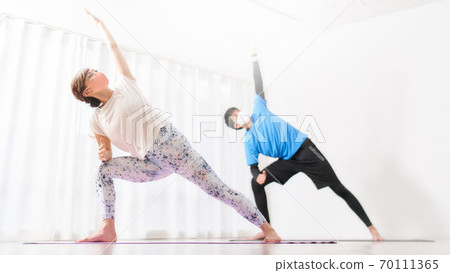 Women and men doing yoga with masks Women and men doing yoga with masks 70111365