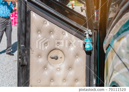 Blue alcohol gel bottle hanging on the door of the double-decker bus to serve passengers and prevent the spread of Corona Virus (Covid-19). Travel safely on public transport. New normal lifestyle. Blue alcohol gel bottle hanging on the door of the double-decker bus to serve passengers and prevent the spread of Corona Virus (Covid-19). Travel safely on public transport. New normal lifestyle. 70111520