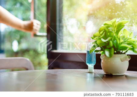 Blue alcohol gel bottle for hand cleaning to prevent the spreading of the Coronavirus (Covid-19), Placed on table to service for customers in the cafe. Healthcare concept. New normal lifestyle 70111683