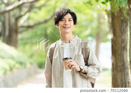 Young man taking a walk Young man taking a walk 70112086
