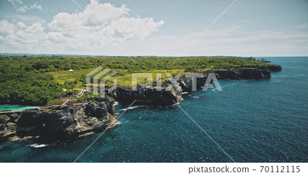 Green cliff shore of sea bay with emerald lake on top. Amazing wild nature landscape of tropic trees 70112115