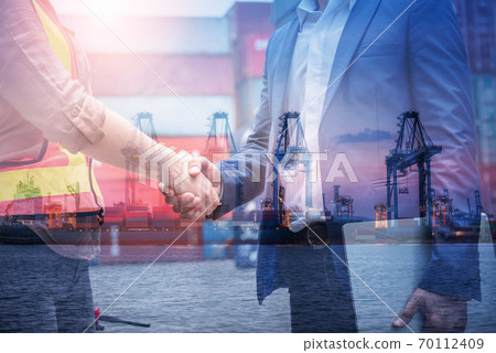 Double Exposure of Businessman and Container Shipping Worker Greeting Handshake Together With Containers Cargo Ship Port Terminal. Transportation Freight for Import/Export of Shipment Service Industry Double Exposure of Businessman and Container Shipping Worker Greeting Handshake Together With Containers Cargo Ship Port Terminal. Transportation Freight for Import/Export of Shipment Service Industry 70112409