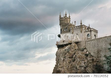 Castle swallow's nest, stands on a rock at the cliff on the background of the black sea. 70114352