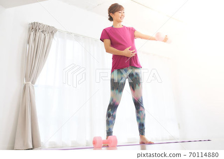 Pregnant woman exercising in the room 70114880