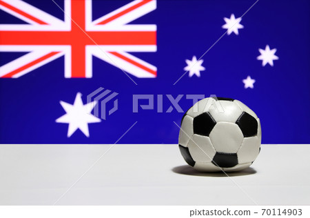 Small football on the white floor and a blue field with the Union Jack 70114903