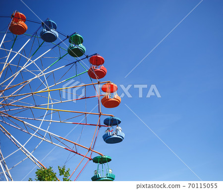 carousel ferris wheel on blue sky background 70115055