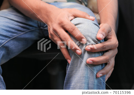 Close up on man suffering knee joint pain 70115396