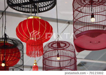 Red fabric lamps and bird cage lamps hanging on the ceiling. Red fabric lamps and bird cage lamps hanging on the ceiling. 70115802