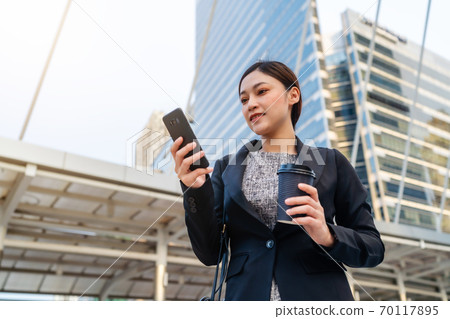 business woman using smartphone in city 70117895
