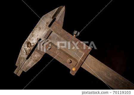 Old tools in front of a black background 70119103