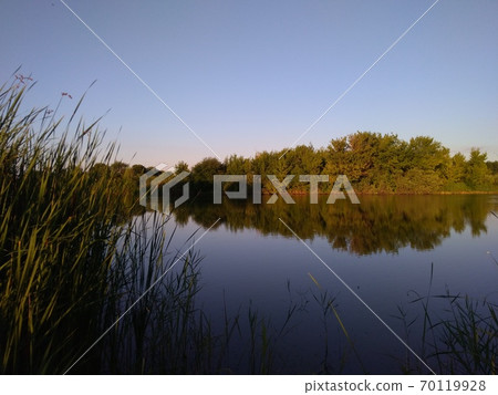 Fishing at sunset, reflection in the water Fishing at sunset, reflection in the water 70119928