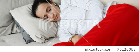 Woman in business clothes is sleeping on couch. 70120093