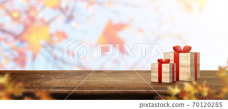 Autumn background.gift box on old rustic wood table with blur forest tree with sunlight,Autumn fall backdrop, banner for product display for advertise on online,thanksgiving concept 70120285