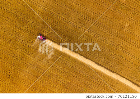 Top view of combine on harvest field Top view of combine on harvest field 70121150