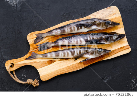 Top view of fresh icefish on wooden cutting board 70121863