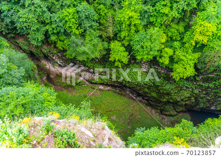 Macocha Abyss - large limestone gorge in Moravian Karst, Czech: Moravsky Kras, Czech Republic. View from the top - upper lookput platform 70123857
