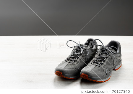trekking sneakers with red sole, gray copy-space background trekking sneakers with red sole, gray copy-space background 70127540