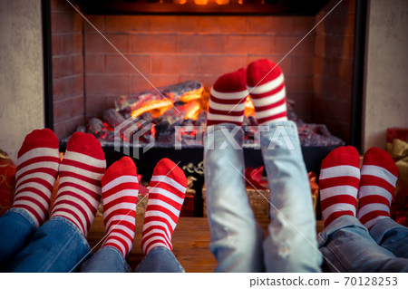 Happy family with children near fireplace at Christmas Happy family with children near fireplace at Christmas 70128253