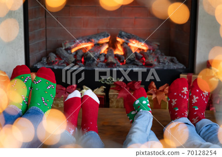 Happy family with children near fireplace at Christmas Happy family with children near fireplace at Christmas 70128254