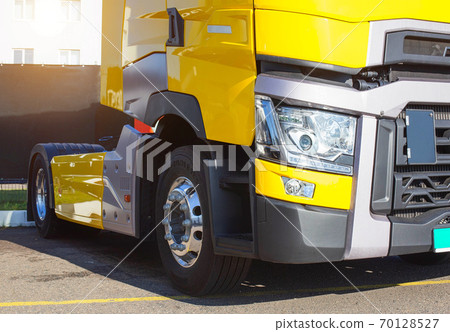 Yellow modern semi-trailer truck with modern LED headlights. Stylish and beautiful truck concept, logistic 70128527