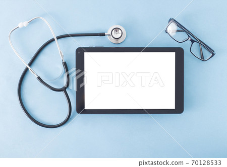 Stethoscope, glasses for vision and a computer tablet with a white background for text. Ophthalmology concept in medicine, technology Stethoscope, glasses for vision and a computer tablet with a white background for text. Ophthalmology concept in medicine, technology 70128533
