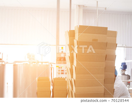 There are many boxes in the production of healthy breakfast cereals from oatmeal and cereals. Food packaging in the factory, copy space for text There are many boxes in the production of healthy breakfast cereals from oatmeal and cereals. Food packaging in the factory, copy space for text 70128544
