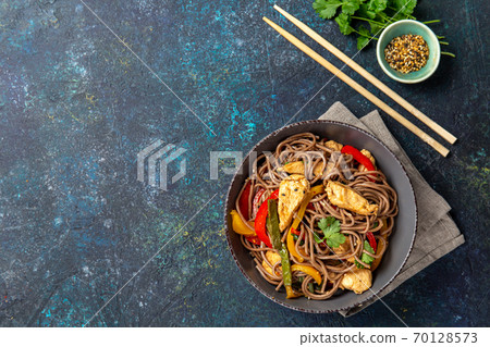 Japanese dish buckwheat soba noodles with chicken and vegetables carrot, bell pepper and green beans 70128573