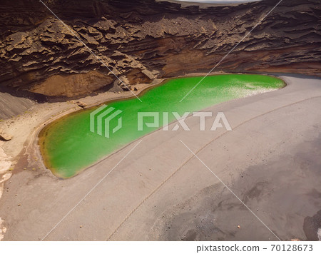 Volcanic crater with a green lake in El Golfo, Lanzarote, Spain. Aerial view Volcanic crater with a green lake in El Golfo, Lanzarote, Spain. Aerial view 70128673