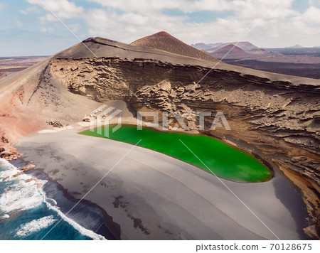 Volcanic crater with a green lake in El Golfo, Lanzarote, Spain. Aerial view Volcanic crater with a green lake in El Golfo, Lanzarote, Spain. Aerial view 70128675