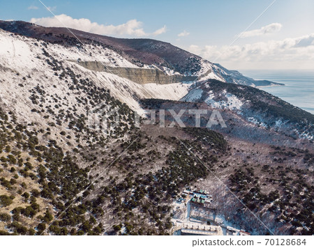 Canyon with snow and trees in winter. Aerial view of canyon with sunlight Canyon with snow and trees in winter. Aerial view of canyon with sunlight 70128684