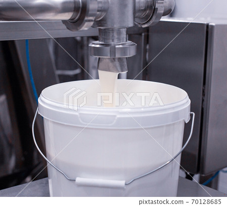 Production and bottling of kefir in dairy production, background, close-up 70128685