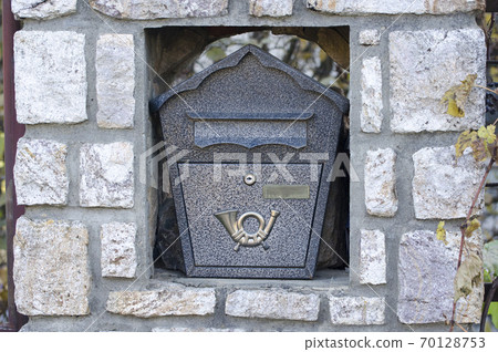 Decorative mailbox on the facade of the house. Decorative mailbox on the facade of the house. 70128753