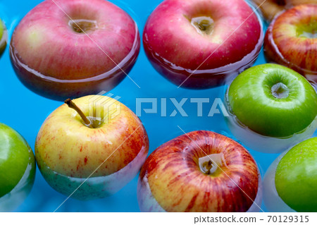 Washing fresh apples in the water 70129315