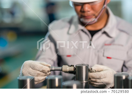 Worker use outside micrometer inspection high product in the production line 70129580