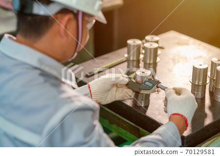 Production worker use outside micrometer inspection high metal product 70129581
