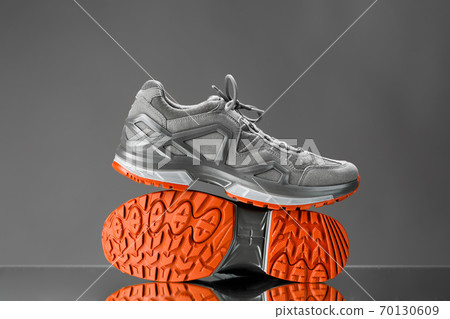 trekking sneakers with red sole, gray background trekking sneakers with red sole, gray background 70130609