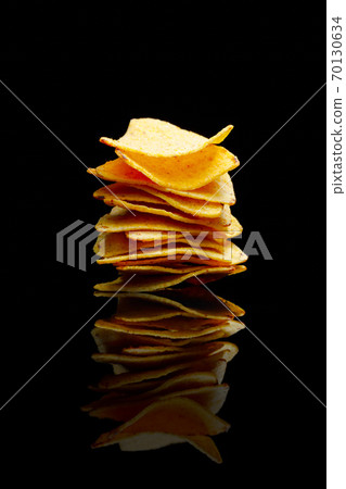 mexican nachos tortilla chips stack, black background 70130634