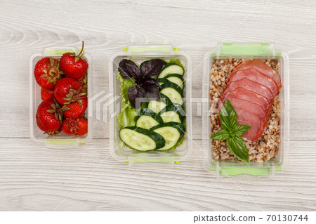 Plastic meal prep containers with meat, boiled buckwheat, vegetables and berries Plastic meal prep containers with meat, boiled buckwheat, vegetables and berries 70130744
