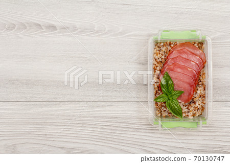 Plastic meal prep container with boiled buckwheat porridge and meat 70130747