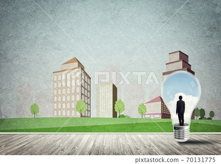 Businessman trapped in bulb Businessman trapped in bulb 70131775