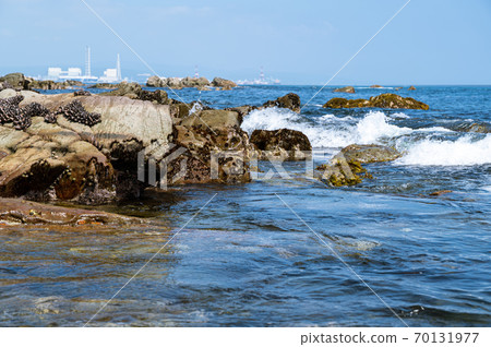 A distant view of the rocks on the coast and the town A distant view of the rocks on the coast and the town 70131977