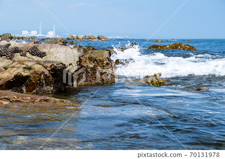 A distant view of the rocks on the coast and the town A distant view of the rocks on the coast and the town 70131978