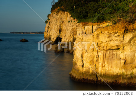 Cliffs and calm sea in the morning sun Cliffs and calm sea in the morning sun 70132008