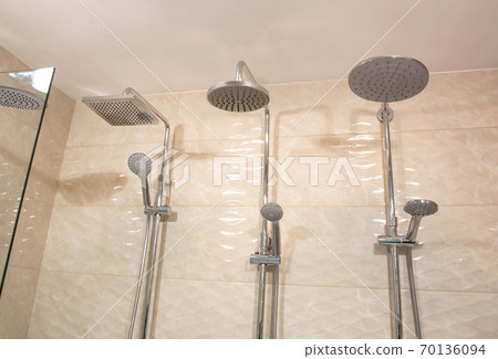 Selling stylish and modern head showers with a water nozzle. Sale of new plumbing, close-up, background, industry Selling stylish and modern head showers with a water nozzle. Sale of new plumbing, close-up, background, industry 70136094