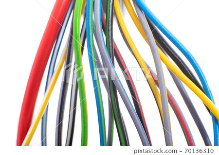 A lot of multi-colored electric wires on a white background. Solid wire with color insulation marked plus and minus, anti-short circuit, macro 70136310